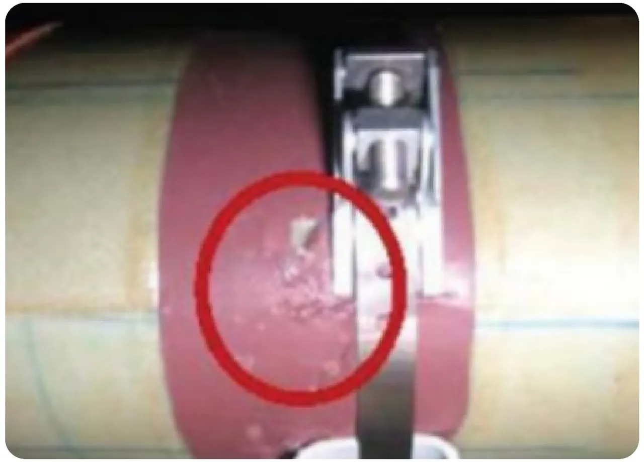 A photo of a damaged part, the defect circled in red