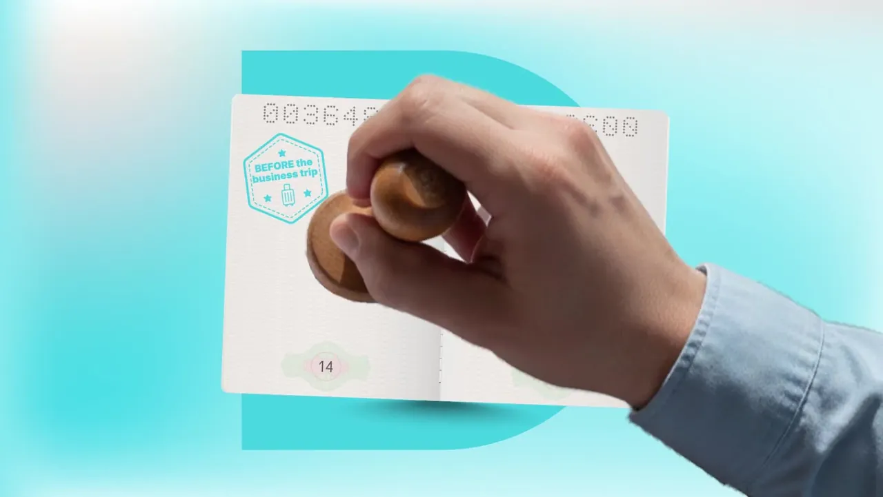 A hand stamping the passport: before the business trip